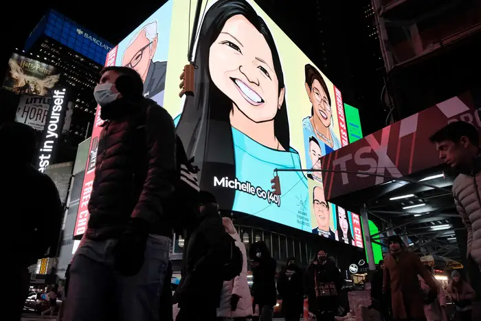 An animated picture of Michelle Go is displayed in Times Square during an evening vigil for the 40- year old New Yorker after she who was killed in a Times Square subway station in January.
